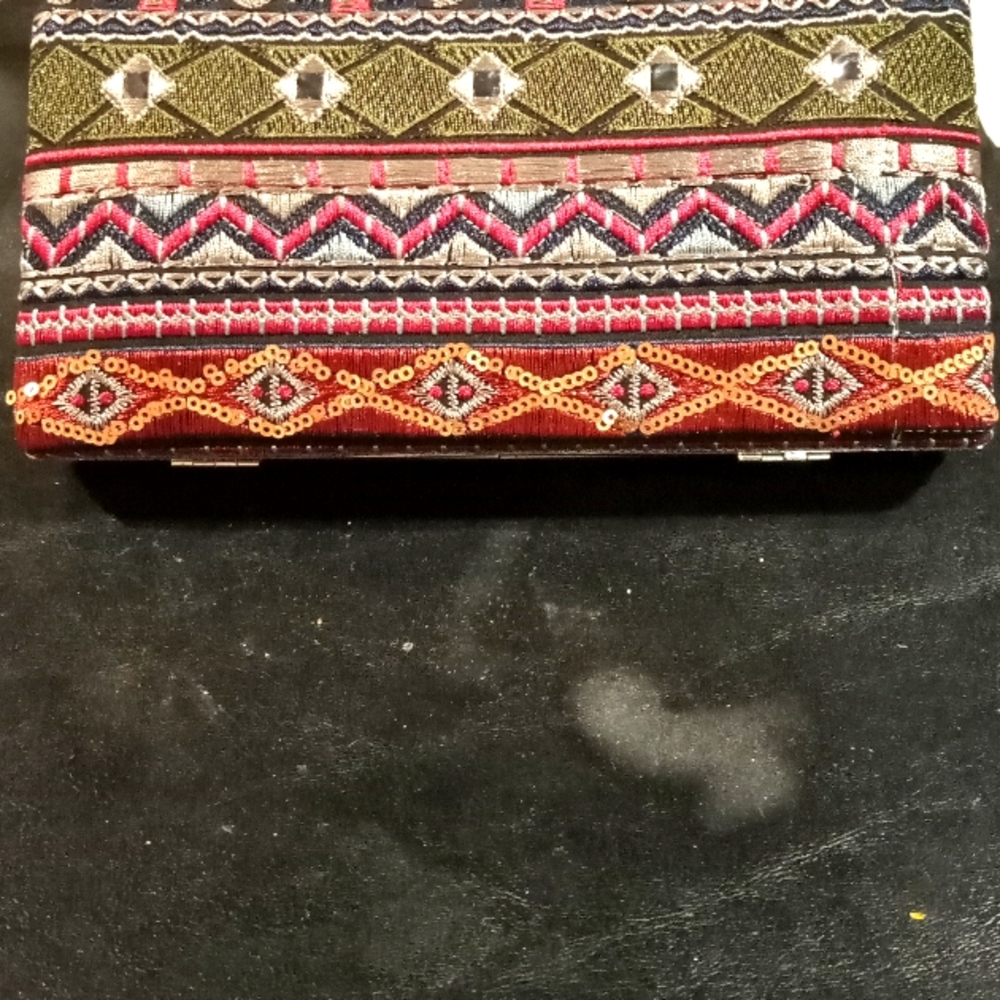 A clutch purse 7 1/2"x7 1/2" red,green,gold,& silver